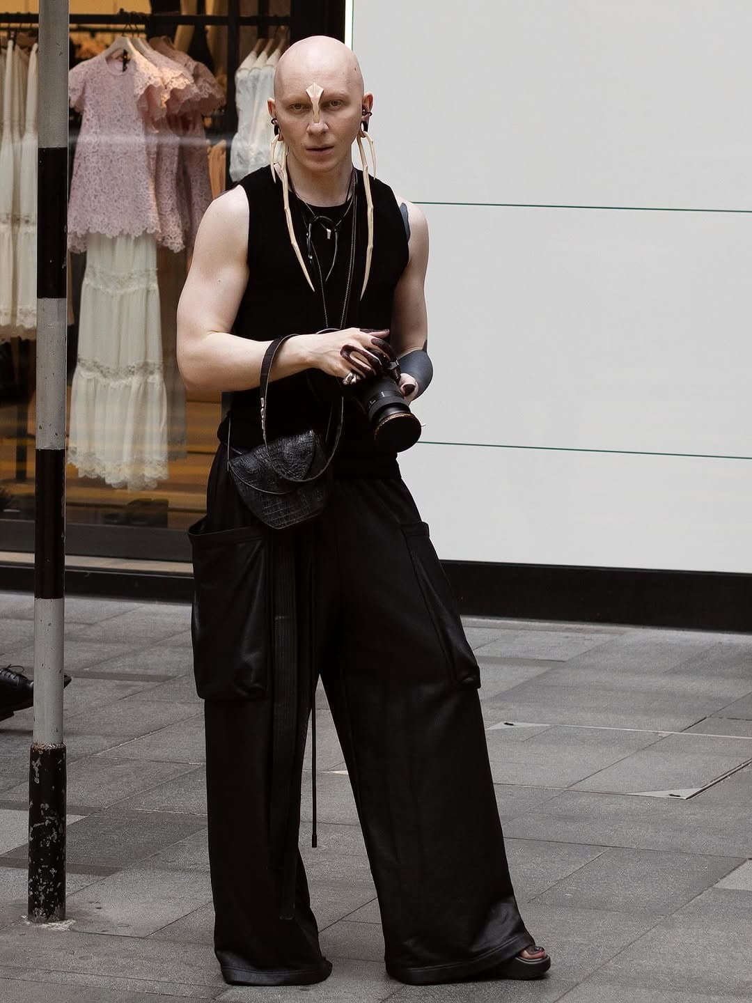 The trousers carry it,
the bone hardware crowns it.