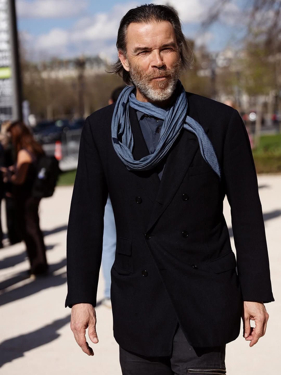 That blue scarf makes
black tailoring breathe.