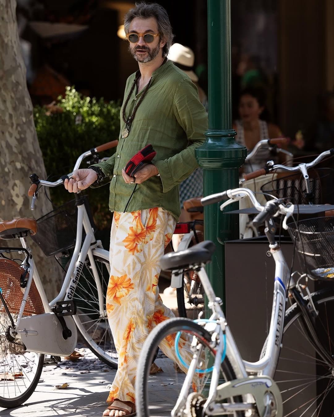 The floral trousers are loud,
and the olive shirt knows it.