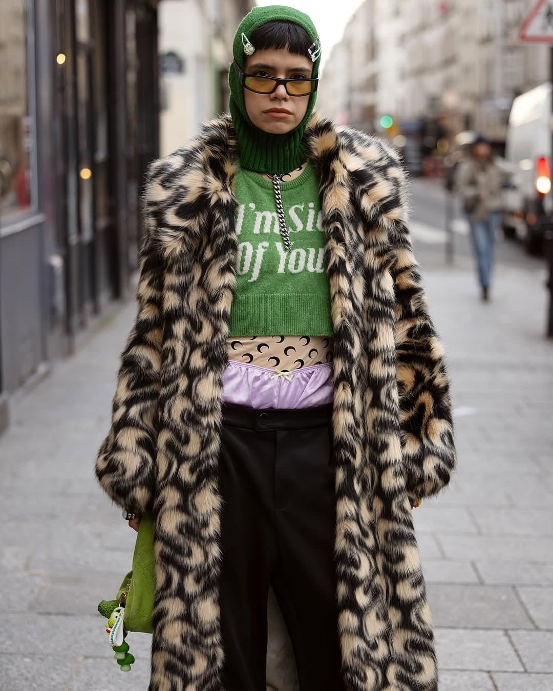 That green hood walks in first,
and the coat follows growling.