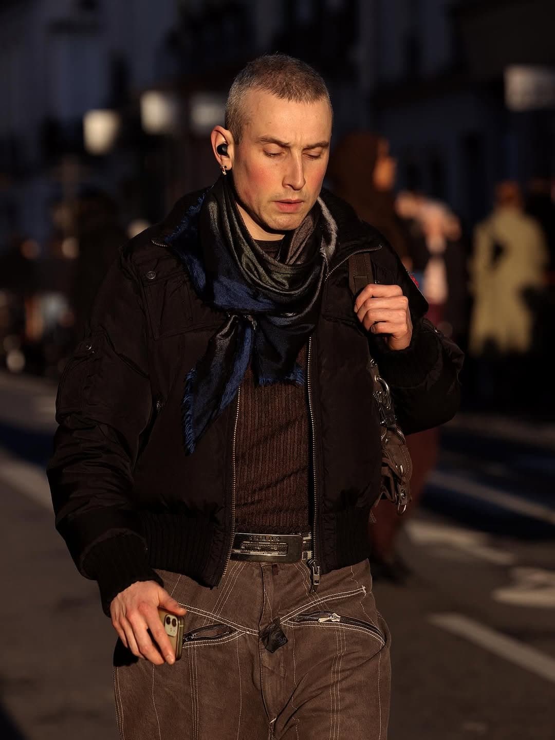 The scarf is loud,
and it earns the room.
