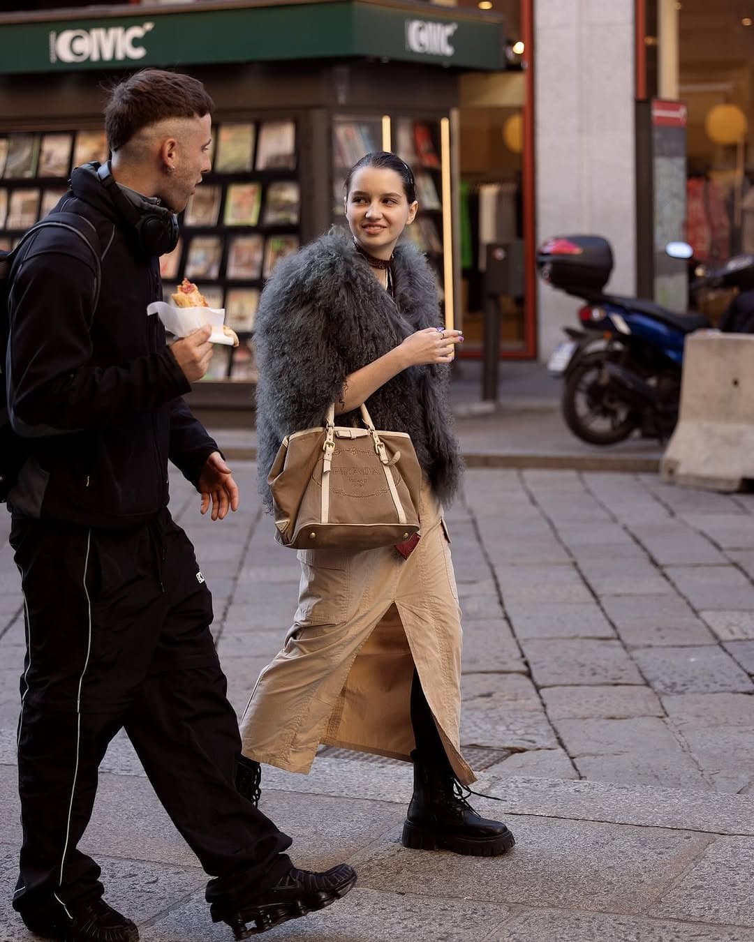 That shaggy jacket enters first,
and the street has to adjust.