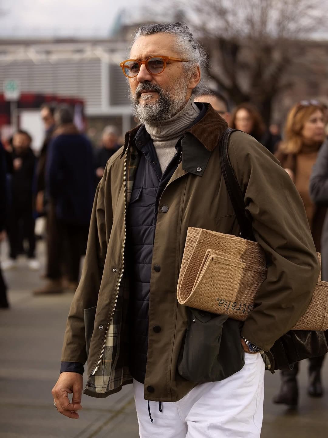 The jacket knows the assignment,
the bags overexplain it.